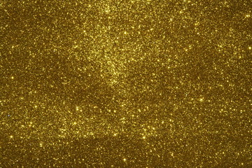 gold Sparkling Lights Festive background with texture. Abstract Christmas twinkled bright bokeh defocused and Falling stars. Winter Card or invitation	