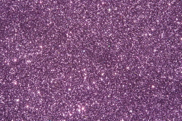 purple Sparkling Lights Festive background with texture. Abstract Christmas twinkled bright bokeh defocused and Falling stars. Winter Card or invitation	