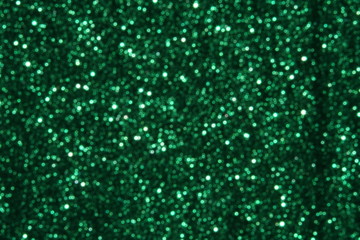 Green Sparkling Lights Festive background with texture. Abstract Christmas twinkled bright bokeh defocused and Falling stars. Winter Card or invitation	