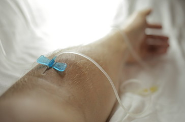 The needle is inserted into a vein in the arm. Dropper for treatment. High quality photo