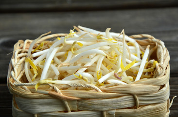 Fresh bean sprout or the sprout of mung bean in basket on wooden background.