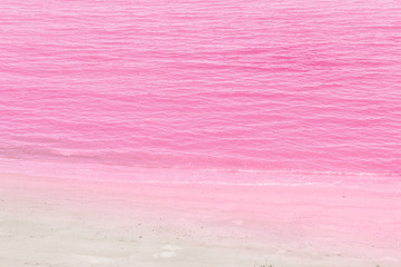 Sea water and pink sand background