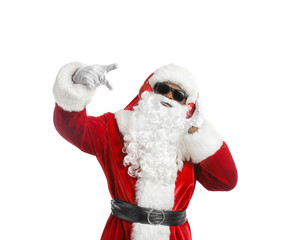Cool African-American Santa Claus listening to music on white background