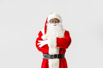 African-American Santa Claus on light background
