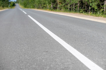 White dividing line on the asphalt road.