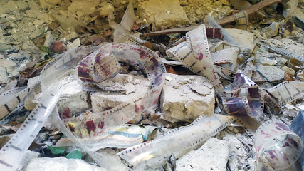 Old dusty film among the rubble of a building. Old film among the rubble of bricks.