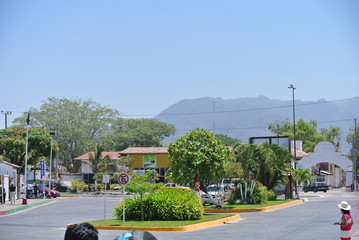 Naklejka premium Puerto Vallarta Mexico,19th april 2013,no parking sign on road in mexico , vehicles are parked opposite to the sign ,tourists are enjoying their day during sunny day
