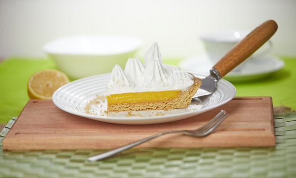 Yummy lemon meringue pie on wooden table