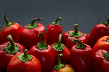 Seasonal red bell pepper on a dark gray background. Copy space. Harvest from your garden.