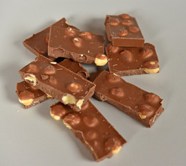Crumbled Hazelnut milk chocolate cubs with pieces of nuts
