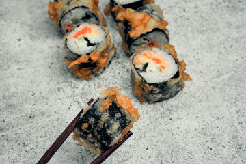 Traditional Japanese food, sushi and rolls. Ginger and wasabi, Chinese sticks. Rice and seafood food. Close up