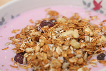 Healthy breakfast. Nuts, cereals, seeds, raisins, candied fruits and milk yogurt