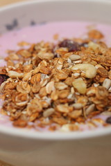Healthy breakfast. Nuts, cereals, seeds, raisins, candied fruits and milk yogurt