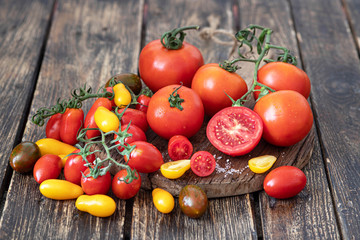 Colorful ripe tomatoes on a wooden table