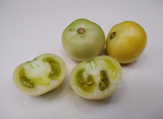 sliced green tomatoes on white background