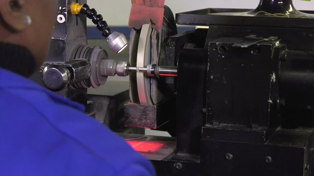 African woman cutting diamond, bruting the girdle shape  edges