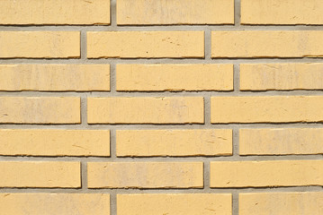 Texture of brick wall. new brickwork. Samples of wall or fence are presented at exhibitions. Yellow brick close up.