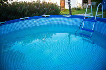 View of a swimming pool being emptied early in the morning  at the end of the summer season