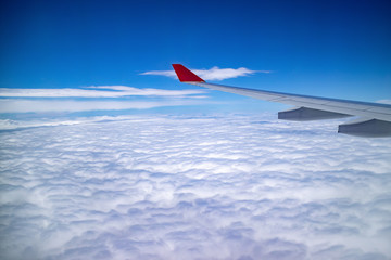 Fototapeta premium Aerial view during flight with clear blue sky and the cloud