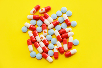 red and white medical capsules and tablets blue
