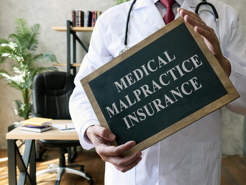 Medical malpractice insurance or professional liability concept. Doctor with blackboard.