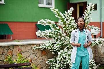 Portrait of African American female doctor with stethoscope wearing lab coat.