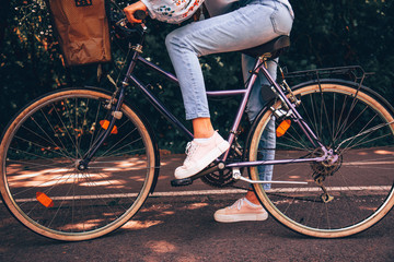 Naklejka premium Attractive beautiful woman riding a bicycle in nature.
