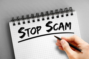 Stop Scam text on notepad, internet concept background