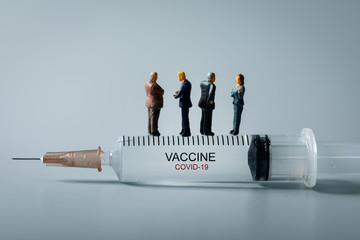 medical industry business people standing on syringe. new covid-19 virus vaccine invention concept