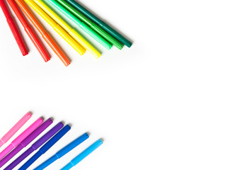 multicolored markers on a white background top view