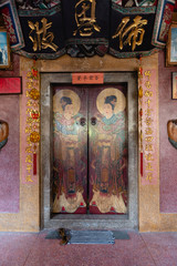 Fototapeta na wymiar Heavy wooden door of a Chinese temple in Thon Buri neighborhood of Bangkok, Thailand
