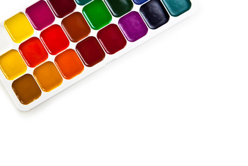 watercolor paints in a box on a white background