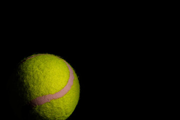 Bright Yellow Tennis Ball with dramatic shadows