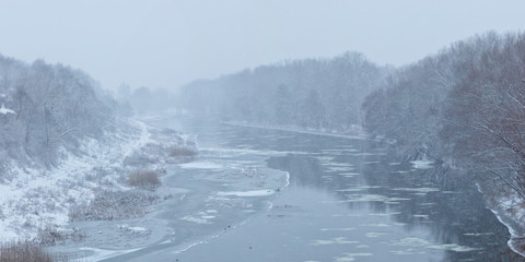 Winter river landscape with fog. Water  pond panorama with snow and ice. Aerial view.