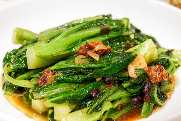 A delicious Cantonese dish, fried lettuce with dace in black bean sauce