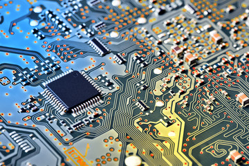 Electronic circuit board with electronic components such as chips close up. Blurry background.	