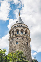 Fototapeta na wymiar Galata Tower on a cloudy summer day, one of the main landmarks of Istanbul, Turkey