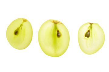 Sweet green grapes sliced in half with moisture on white background isolated on white background