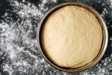Fresh Raw Dough for Preparation Cookies Top View Photo. Ingredient in Metallic Bowl For Cooking Bakery Delicious Meal Dessert and Wheat Flour on Black Kitchen Table. Homemade Culinary Recipe
