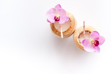 Fototapeta na wymiar Raw coconut cocktail with drinking straw, top view