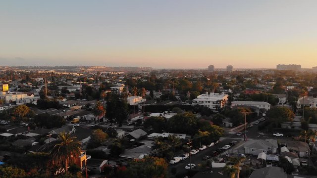 Aerial shot moving sideways over streets in Culver city neighborhood withdowntown in background in Los Angeles, California, USA