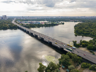 Fototapeta na wymiar Aerial drone view. Cars travel along the North Bridge across the Dnieper in Kiev.