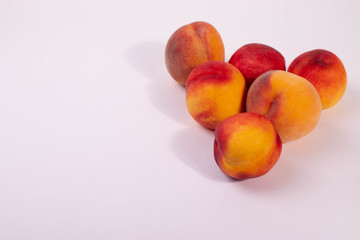 a group of round peaches on the light background