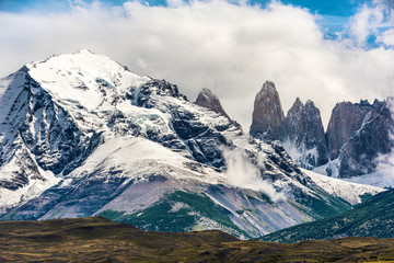 Fototapeta na wymiar Torres del Paine peaks coming from clouds