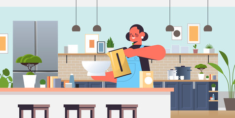 Fototapeta premium happy woman preparing food cooking at home concept modern kitchen interior horizontal portrait vector illustration