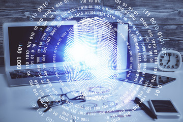 Computer on desktop in office with finger print drawing. Double exposure. Concept of business data security.
