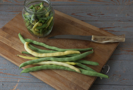 Green beans on wooden cutting board.Cooking green beans for long-term storage in the frezer.