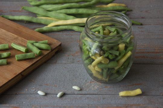 Green beans on wooden cutting board.Cooking green beans for long-term storage in the frezer.