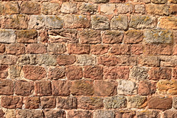 Old brick wall, old texture of red stone blocks closeup
