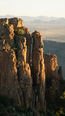 Valley of Desolation Rock Formations and hills during sunset near Graaff Reinet in South Africa.
